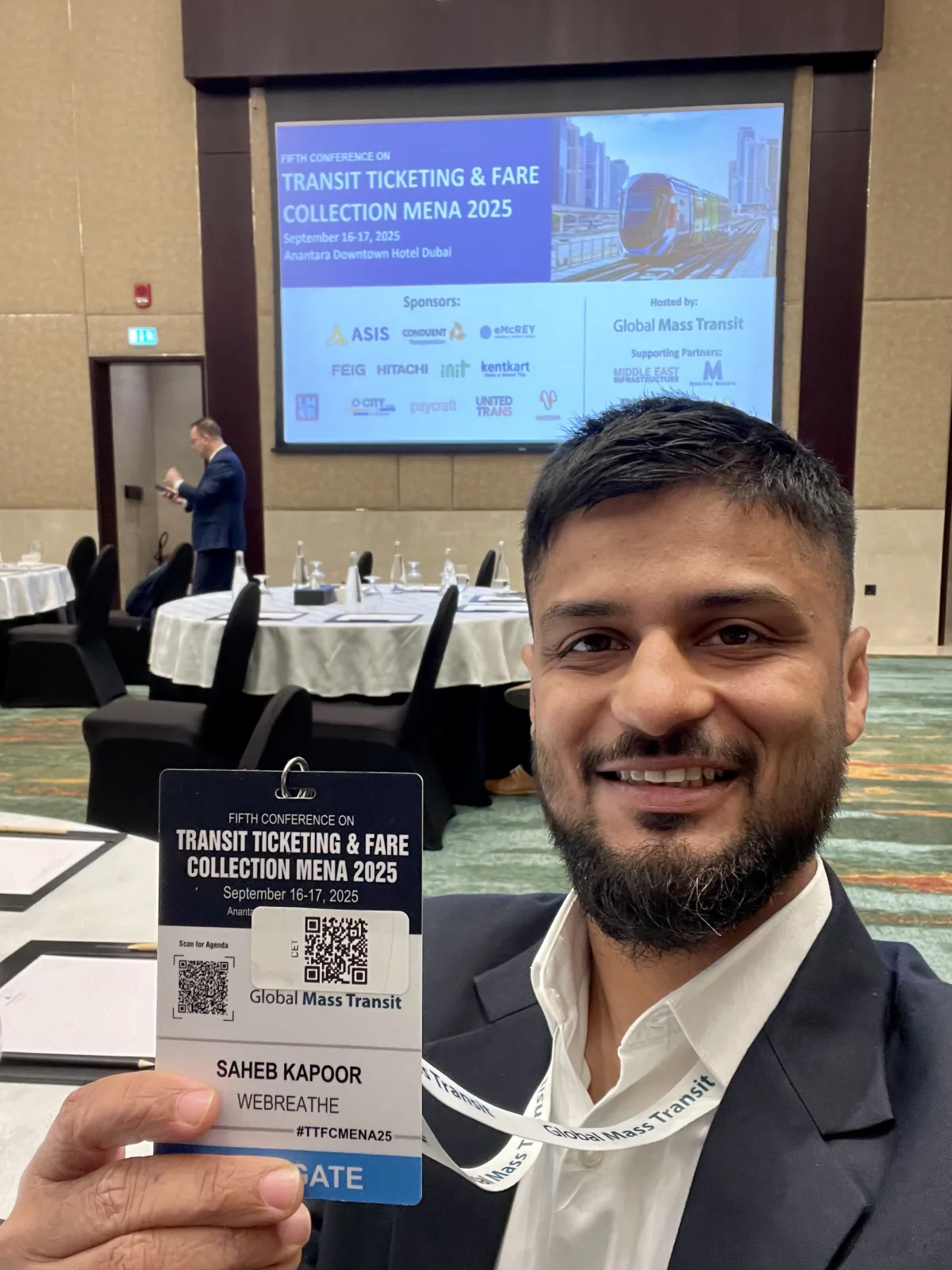 A WEBREATHE delegate holding an event badge at TTFC MENA 2025 in Dubai